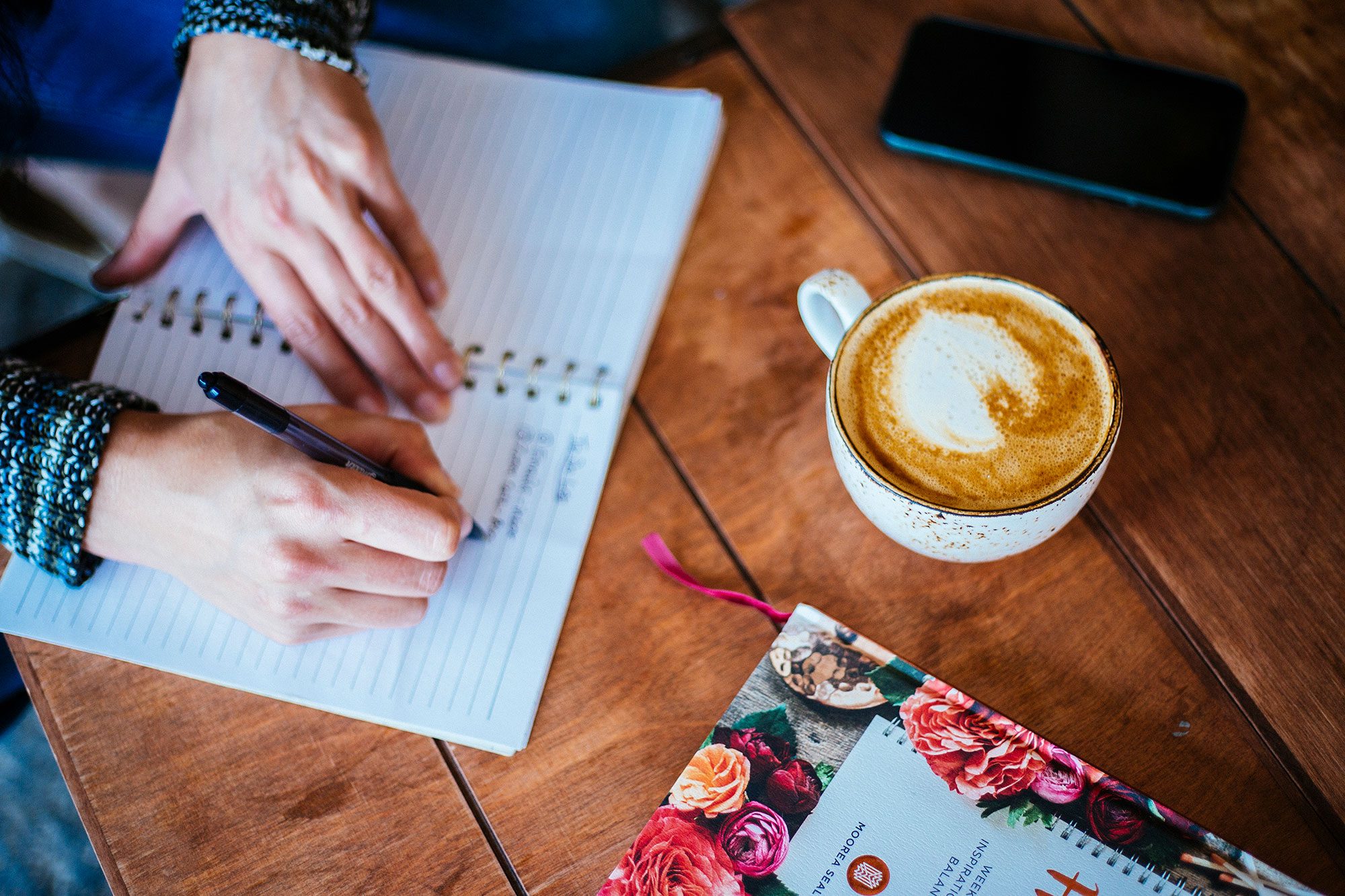 ebb-flow-and-grow-laura-writing-into-notebook-with-latte-art-compressed